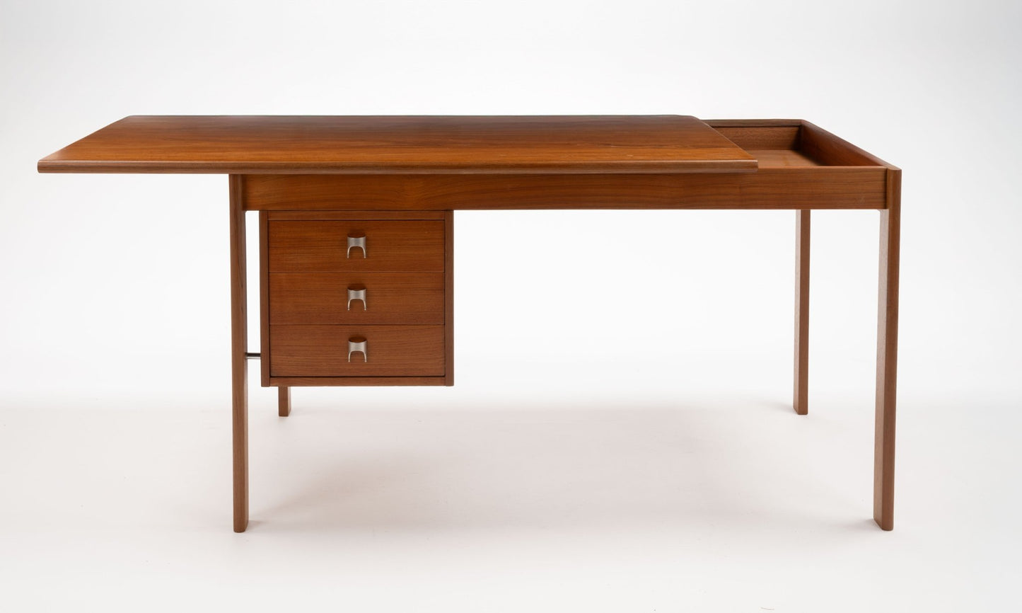Mid-century modern teak writing desk by Peter Lovig Nielsen with sliding top and three drawers with stainless steel handles