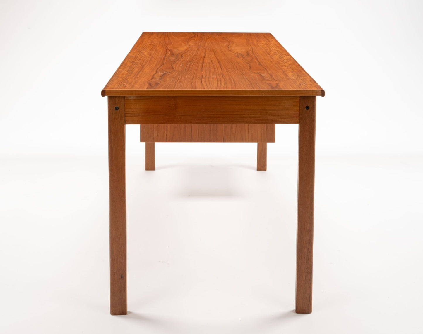 Mid-century modern teak writing desk by Peter Lovig Nielsen with clean lines and minimalist rectangular top.