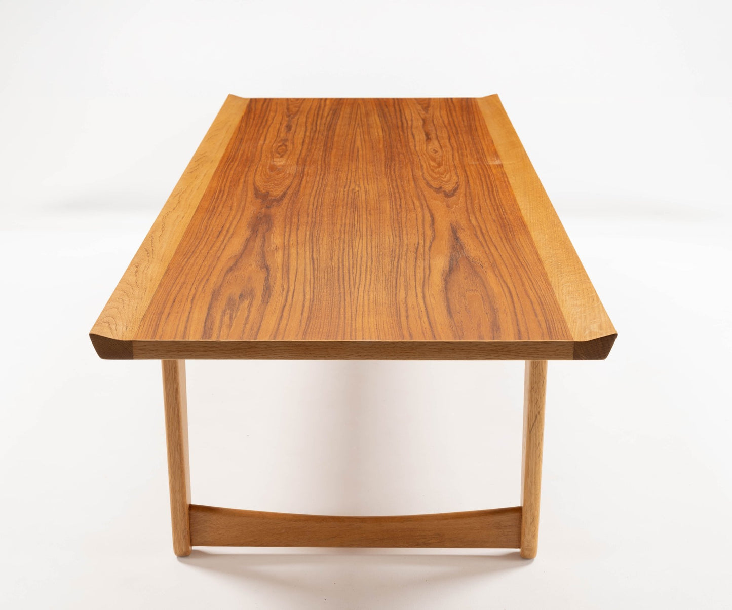 Mid-century modern Yngve Ekstrom coffee table in teak and oak with elegant joined legs, showcasing Scandinavian design.