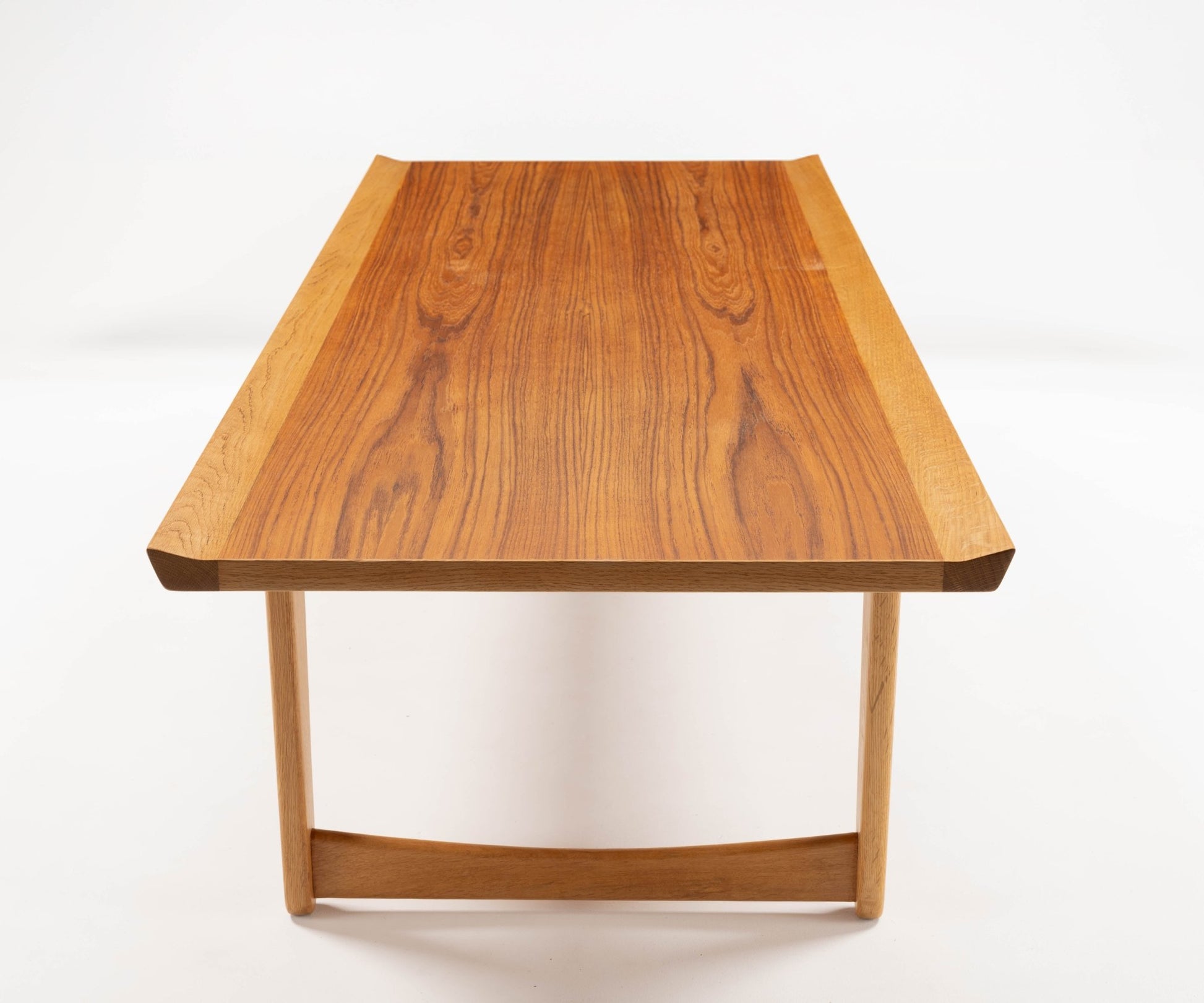 Mid-century modern Yngve Ekstrom coffee table in teak and oak with elegant joined legs, showcasing Scandinavian design.