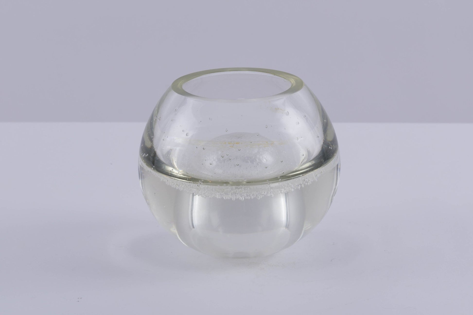 Handblown A.D. Copier Leerdam glass vase with round shape and distinctive small air bubble texture called Spijkerbol.