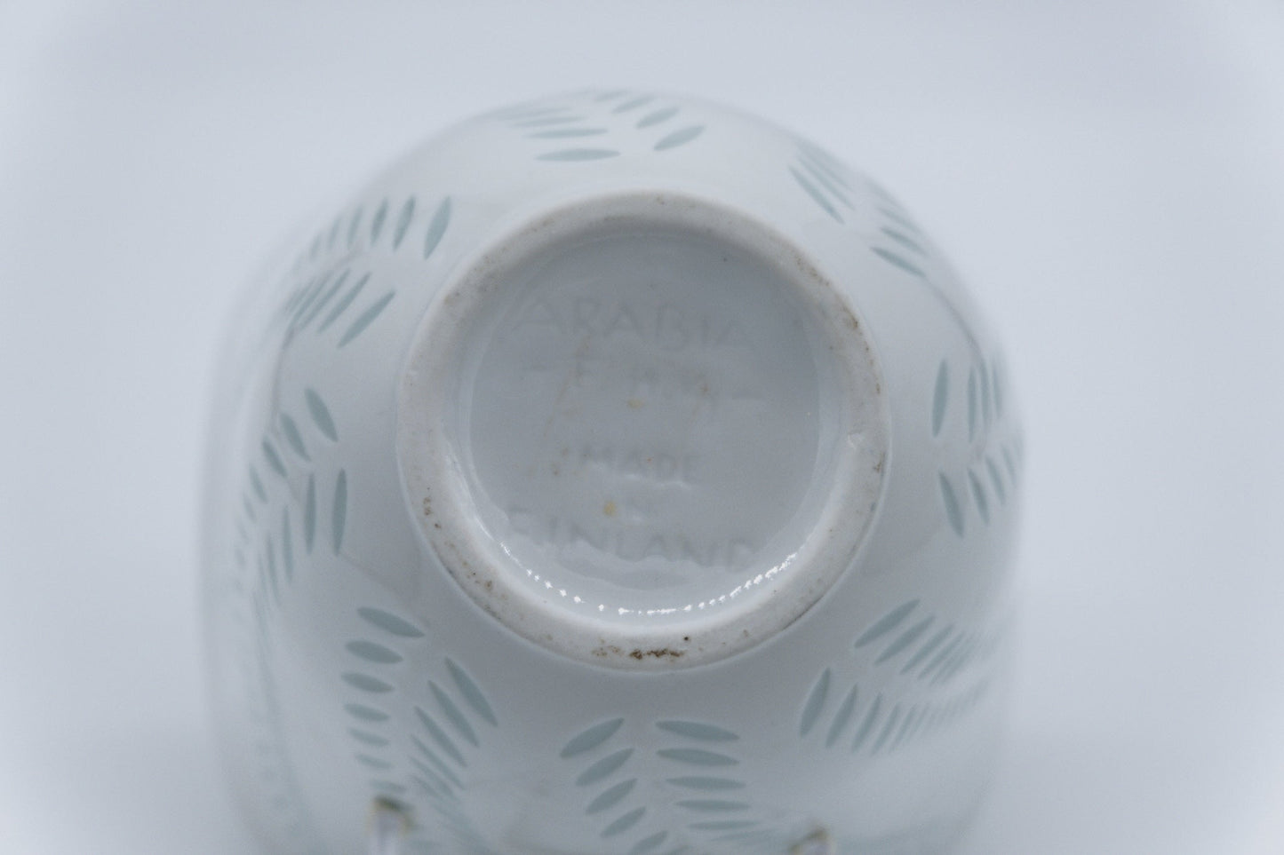 Underside of 1960s Arabia Friedl Holzer-Kjellberg white rice porcelain vase with signature and handmade marks.
