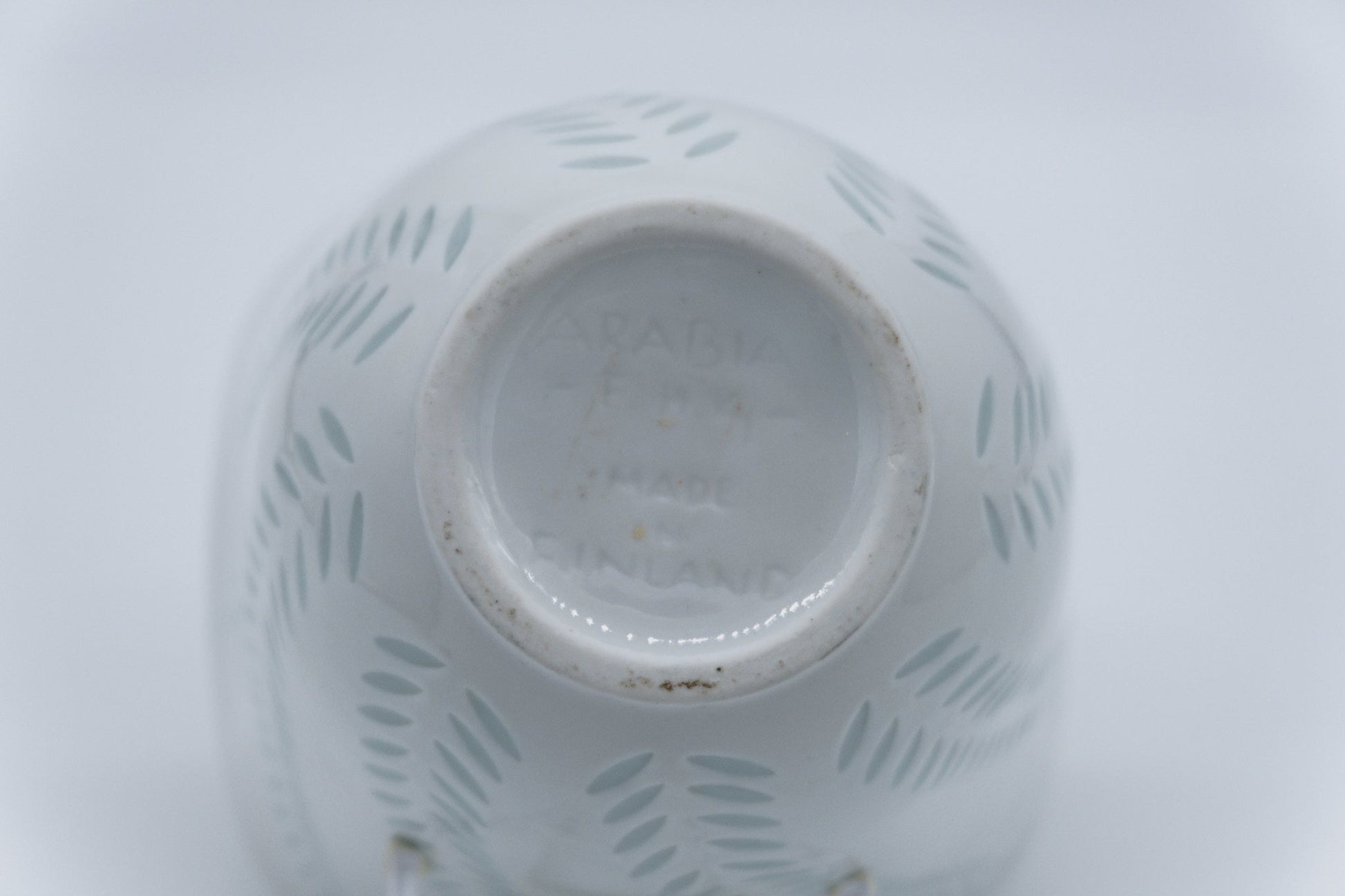 Underside of 1960s Arabia Friedl Holzer-Kjellberg white rice porcelain vase with signature and handmade marks.