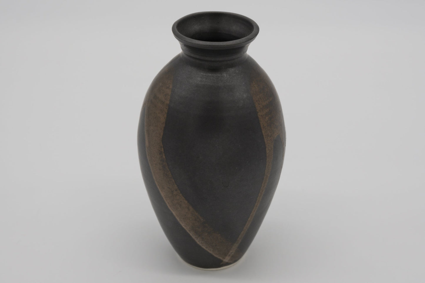 Studio pottery brush marked vase with dark glaze and semi-transparent brush strokes on the body, high choke neck design.