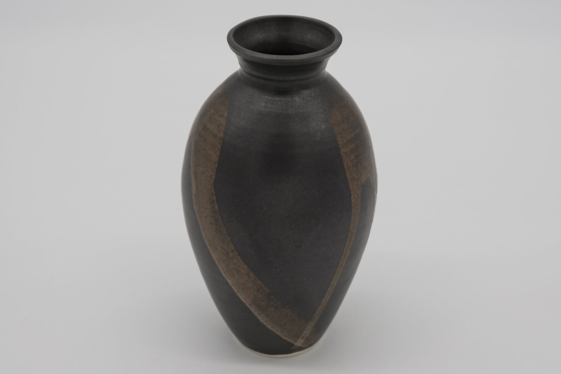 Studio pottery brush marked vase with dark glaze and semi-transparent brush strokes on the body, high choke neck design.