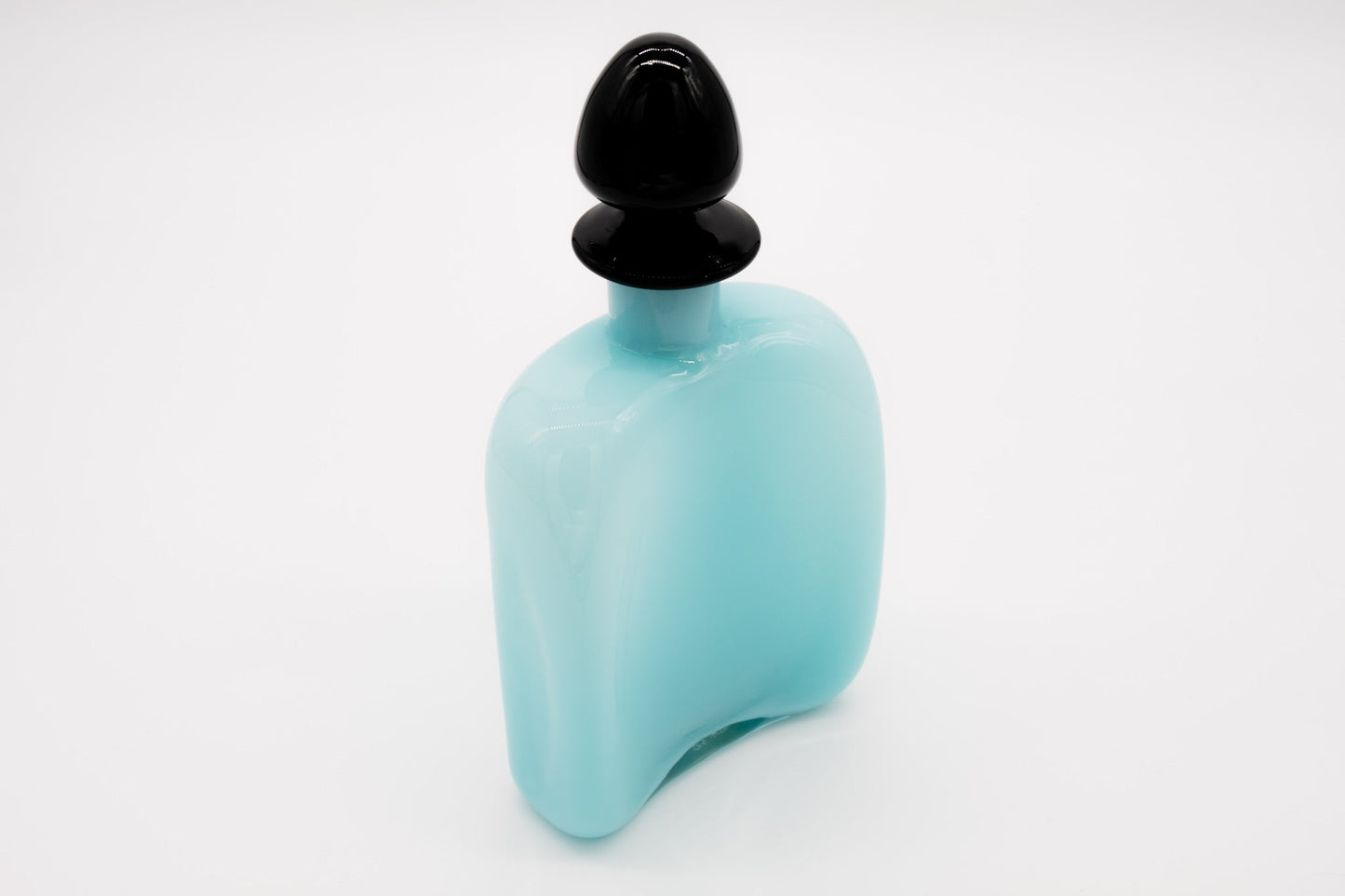 Carlo Moretti Murano glass decanter with black stopper, signed and labeled, in soft blue opaline glass.