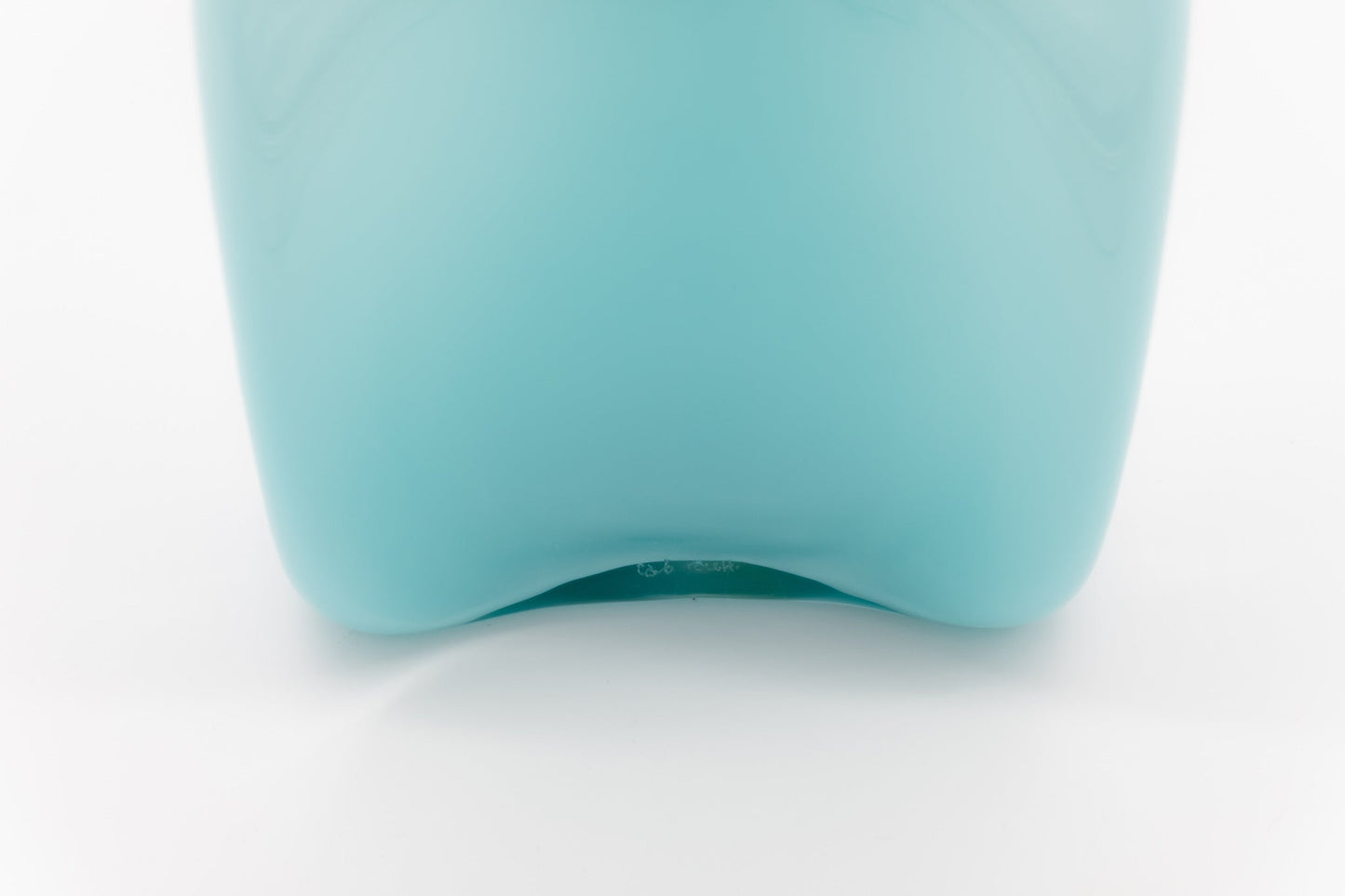 Bottom view of Carlo Moretti Murano glass decanter in pale blue with label and signature on white background
