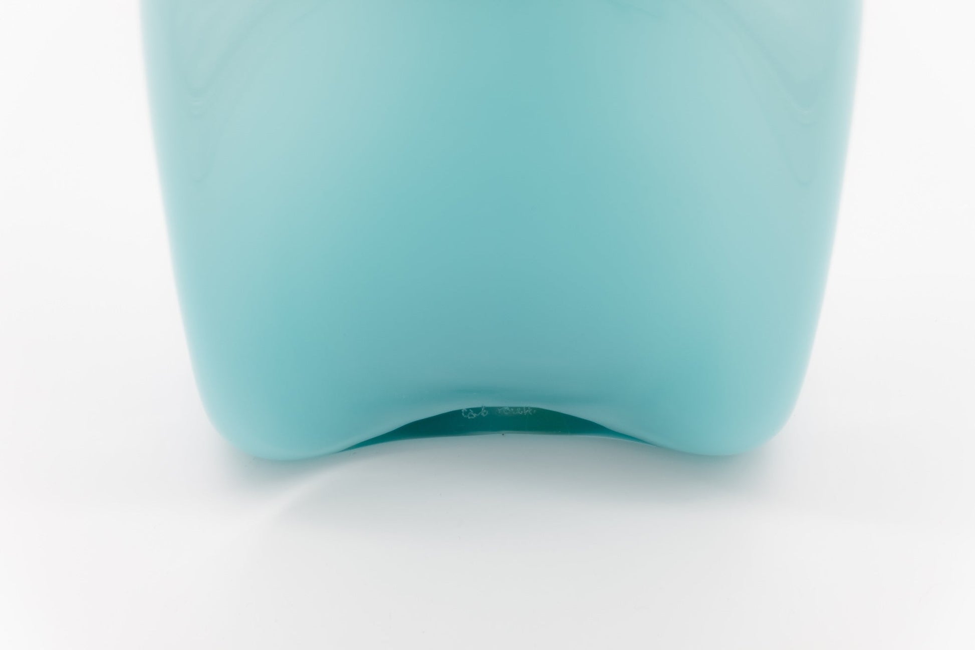 Bottom view of Carlo Moretti Murano glass decanter in pale blue with label and signature on white background