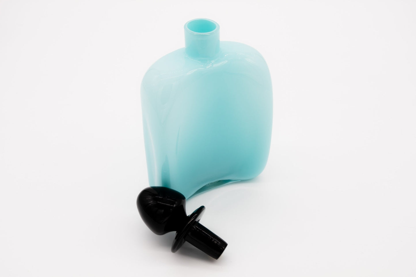 Carlo Moretti Murano glass decanter in light blue with black stopper, signed and labeled, elegant design.