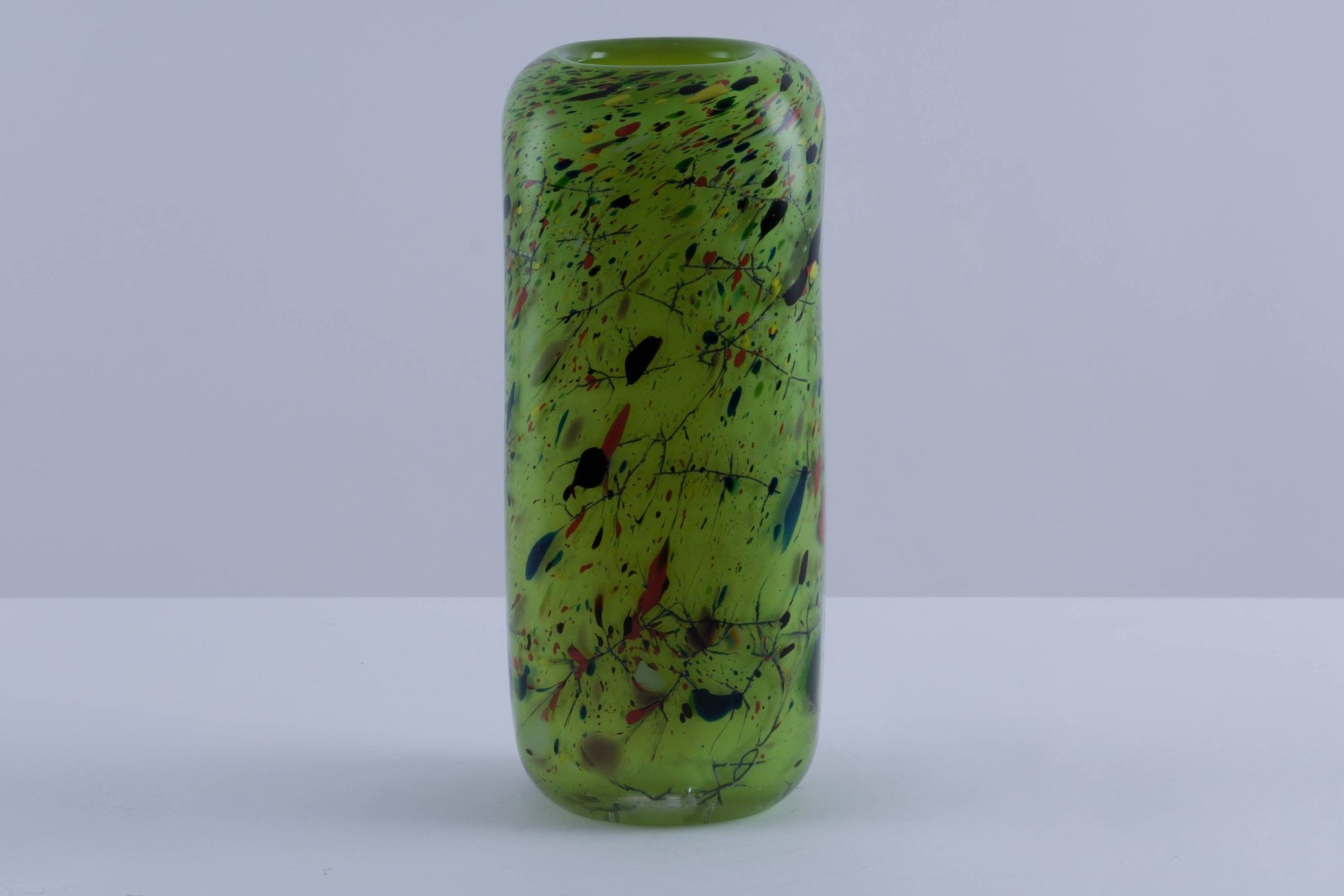 Rectangular vibrant green glass vase with rounded edges and multicolored speckled pattern, thick and heavy-walled design.