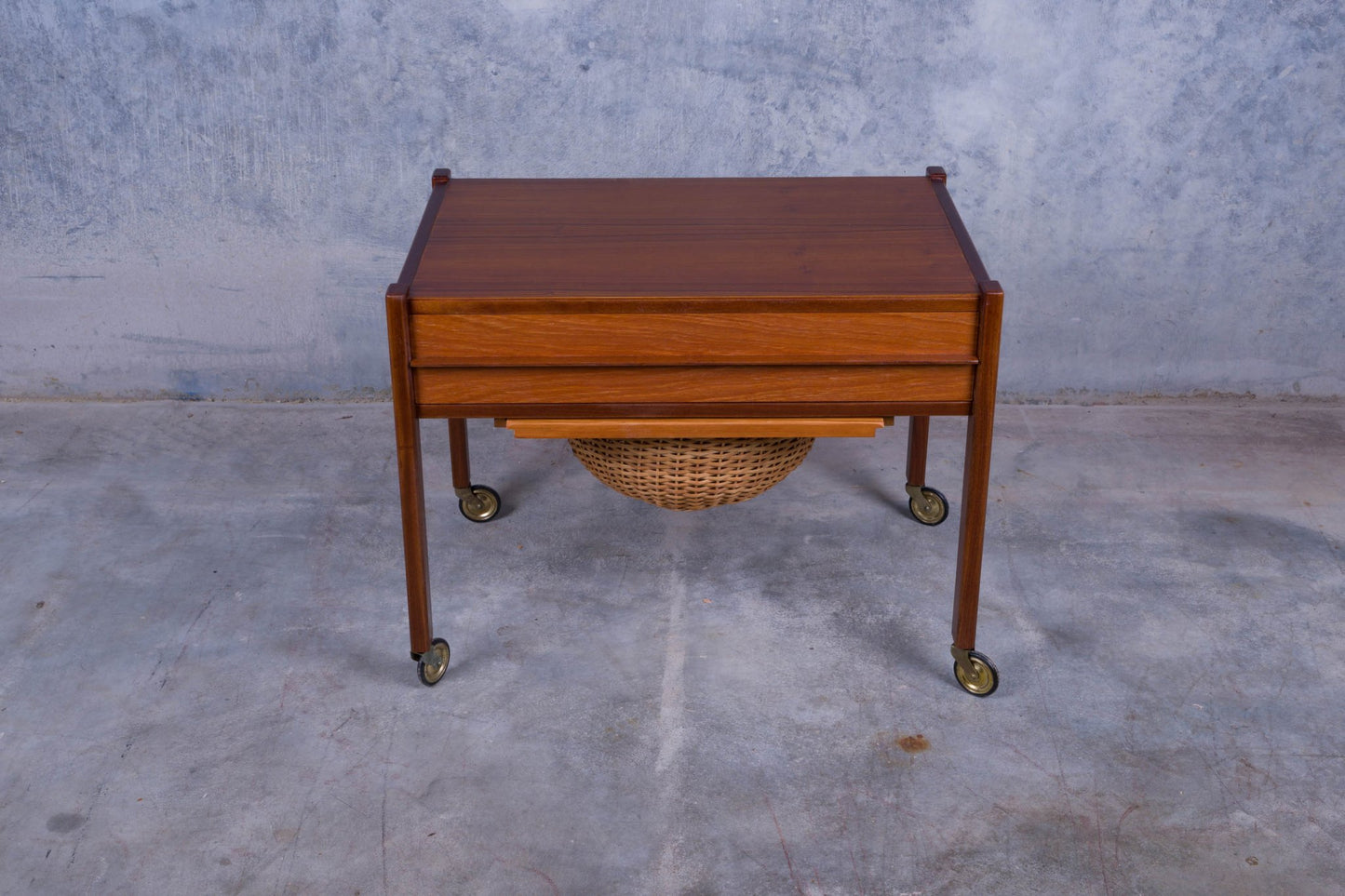 Rolling Danish teak sewing side table with pull-out drawer and slide-out caned circular basket underneath