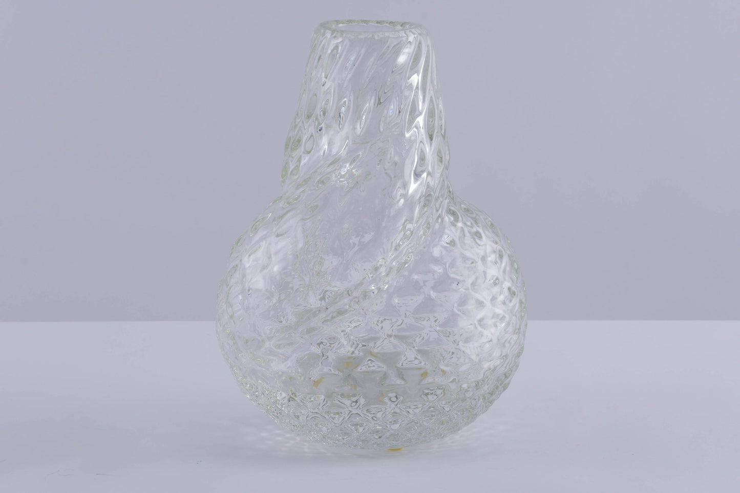 Spiral designed asymmetrical textured glass vessel by Flavio Poli with unique twisted form on light background