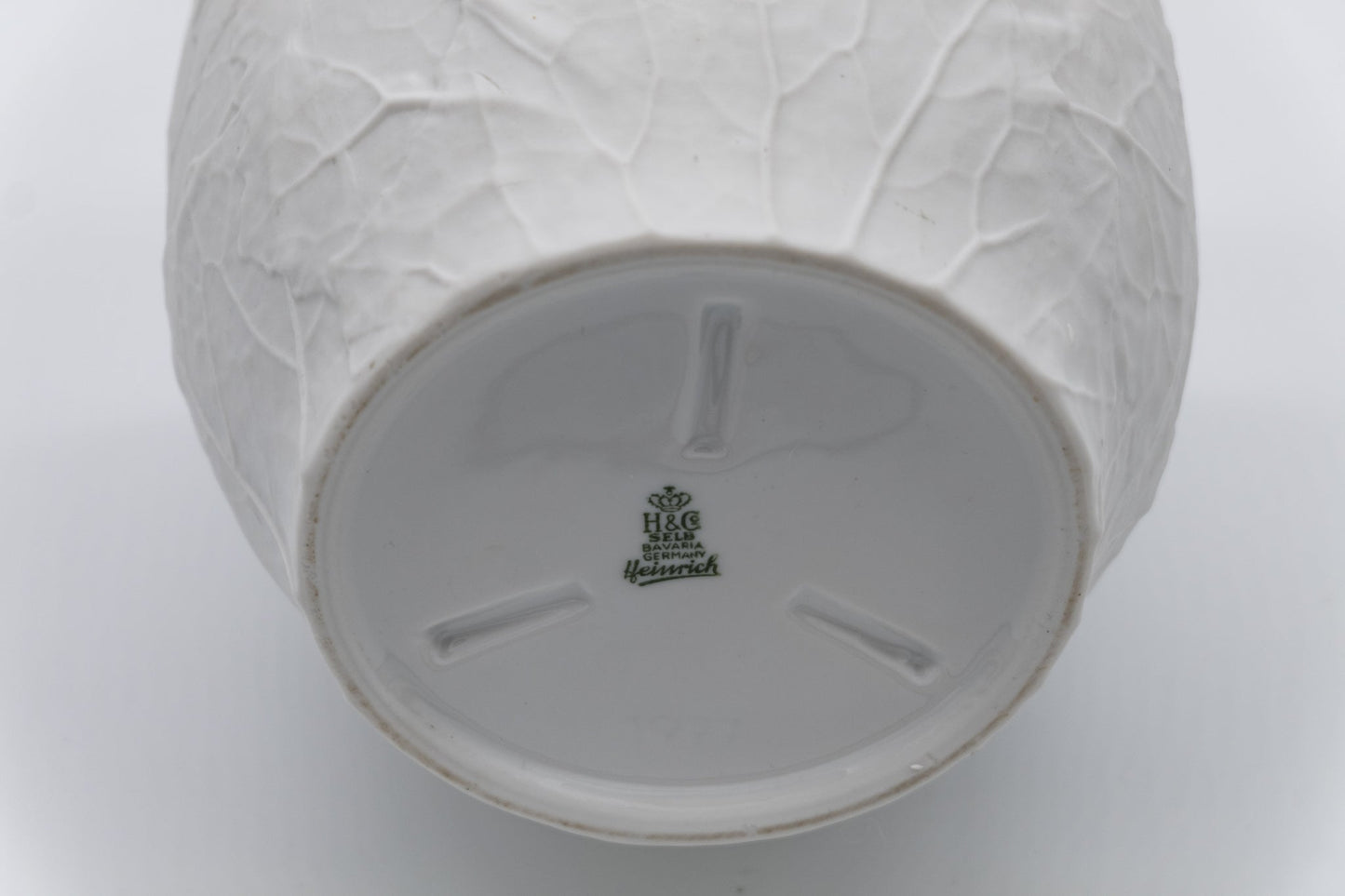 Base of Heinrich & Co. white porcelain vase with raised leaf bisque texture and green factory mark from Germany.