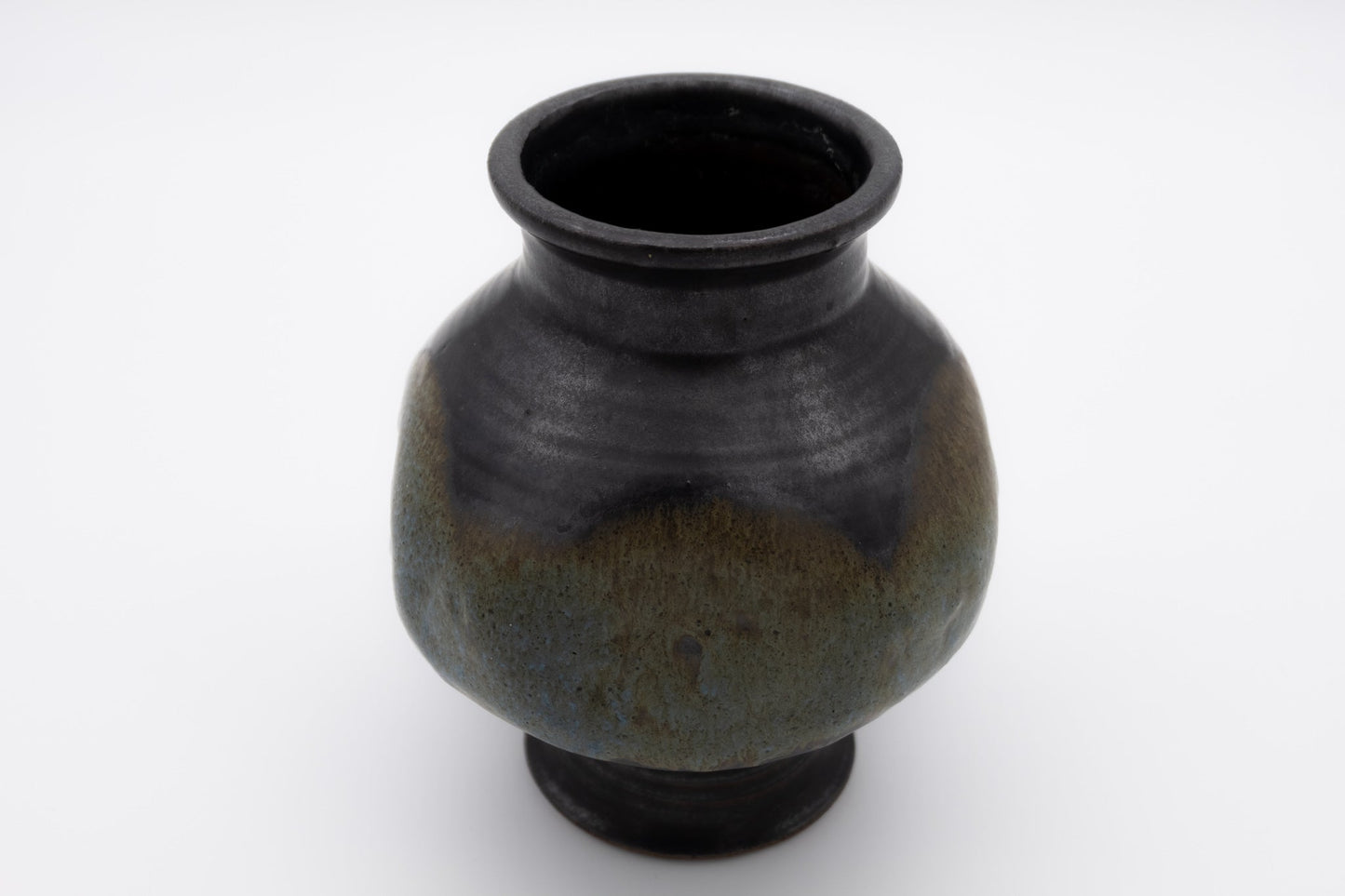Studio pottery spherical vase with unique indented body and multi-colored glaze, signed on the bottom.