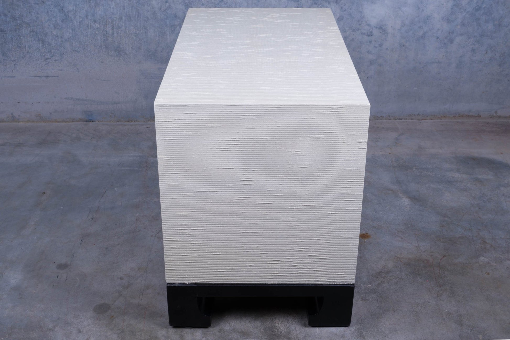 Three drawer James Mont style faux tortoiseshell dresser with white riveted surface and black lacquered carved base.