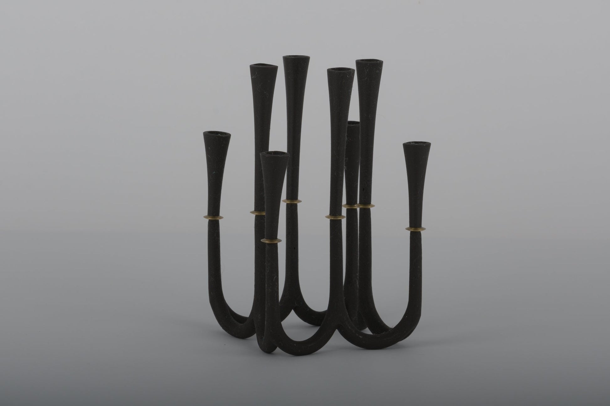 Pair of Jens Quistgaard cast iron candelabras with bronze accents designed for thin Dansk candles from the 1950s