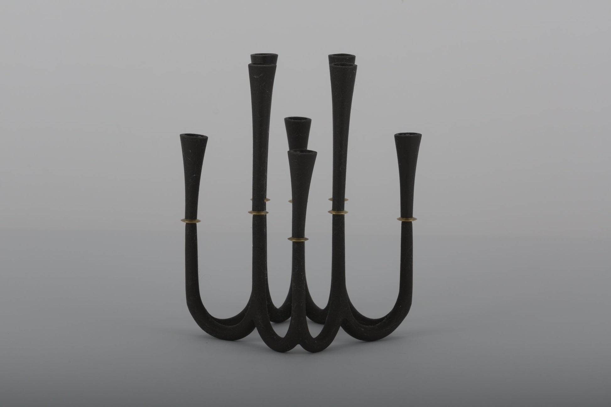 Pair of Jens Quistgaard cast iron candelabra candle holders with bronze accents for thin candles by Dansk Denmark.