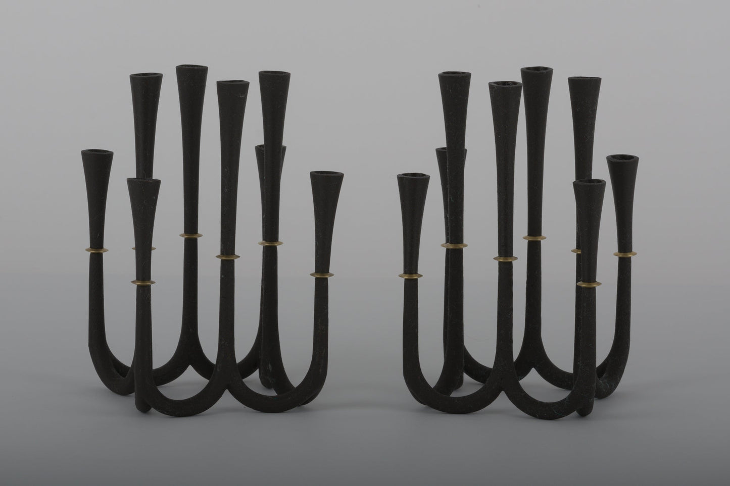 Pair of Jens Quistgaard cast iron candelabra candle holders with bronze accents designed for thin Dansk candles from 1950s