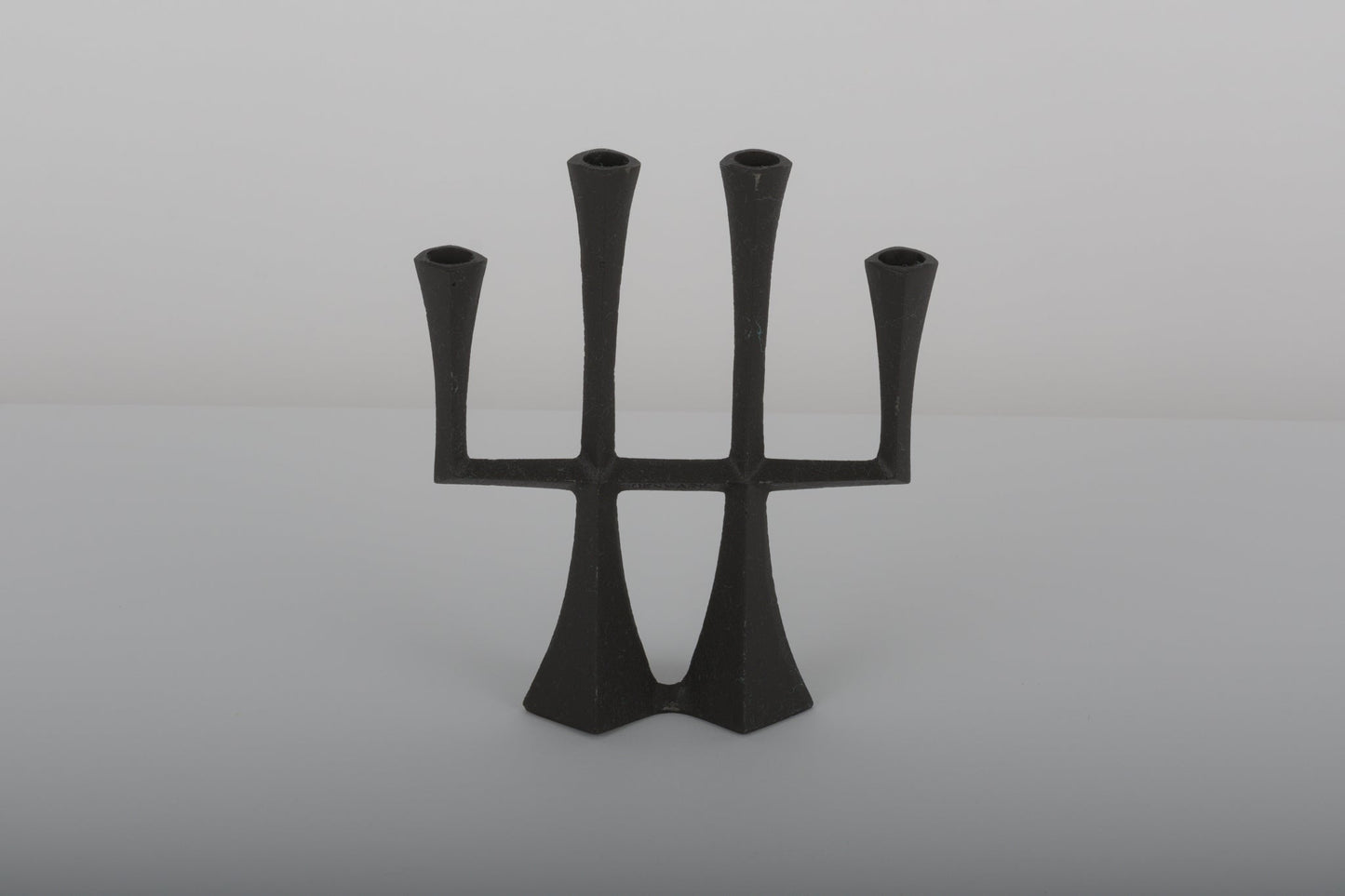 Pair of Jens Quistgaard cast iron Danish candle holders from the 1950s with a sculptural minimalist design.