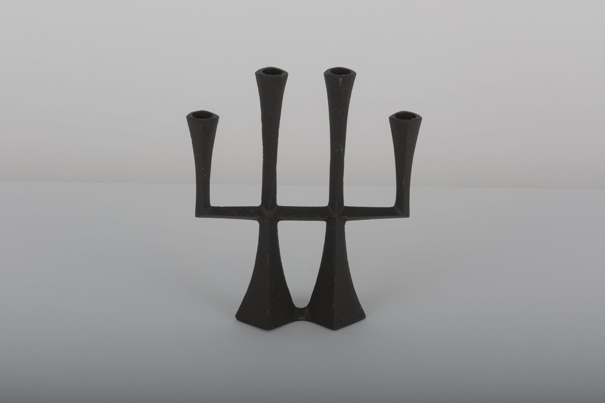 Pair of Jens Quistgaard cast iron Danish candle holders from the 1950s with a sculptural minimalist design.