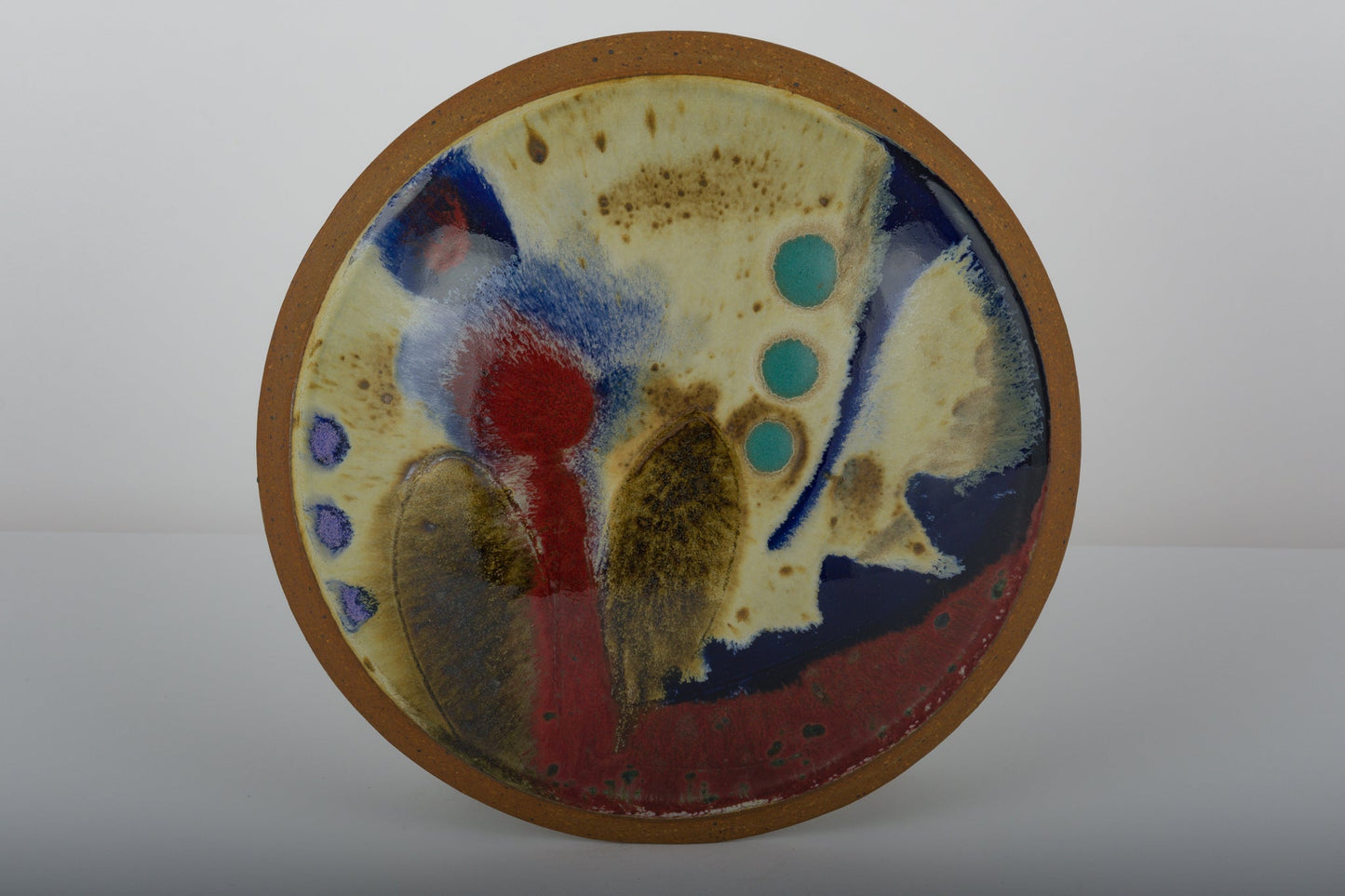 Ken Pick studio pottery vase from the 1980s with abstract multicolor glazing on an oval ceramic surface