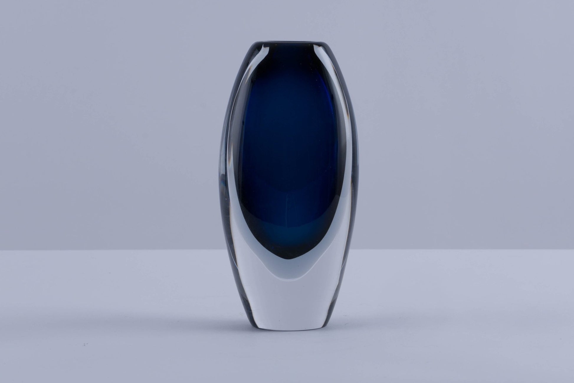 Vicke Lindstrand signed Kosta Boda Sommerso glass vase with deep blue interior encased in clear outer layer, circa 1960s.