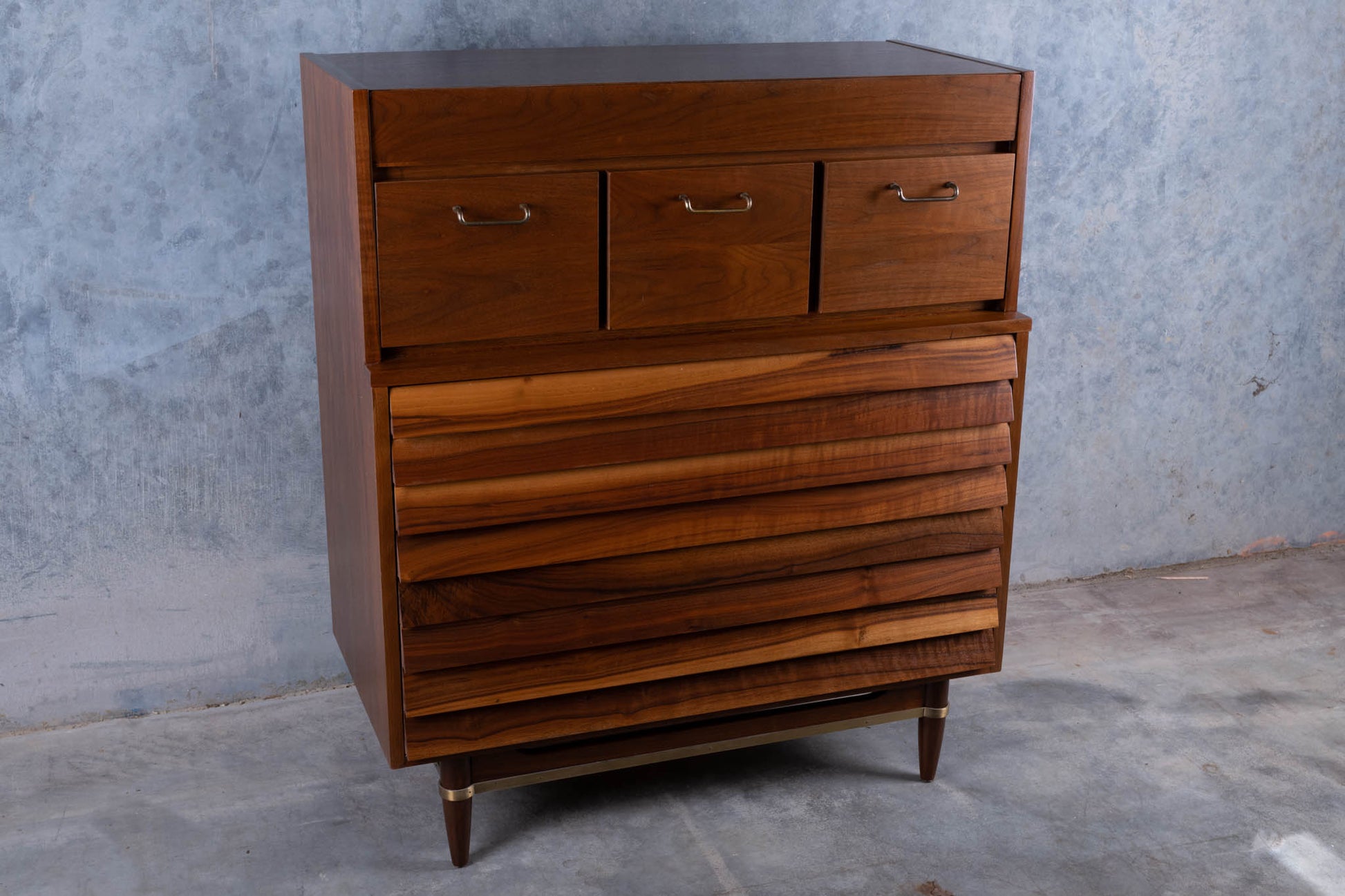 Mid-century modern walnut "Highboy" dresser by Merton L. Gershun with louvered front and seven drawers on tapered legs