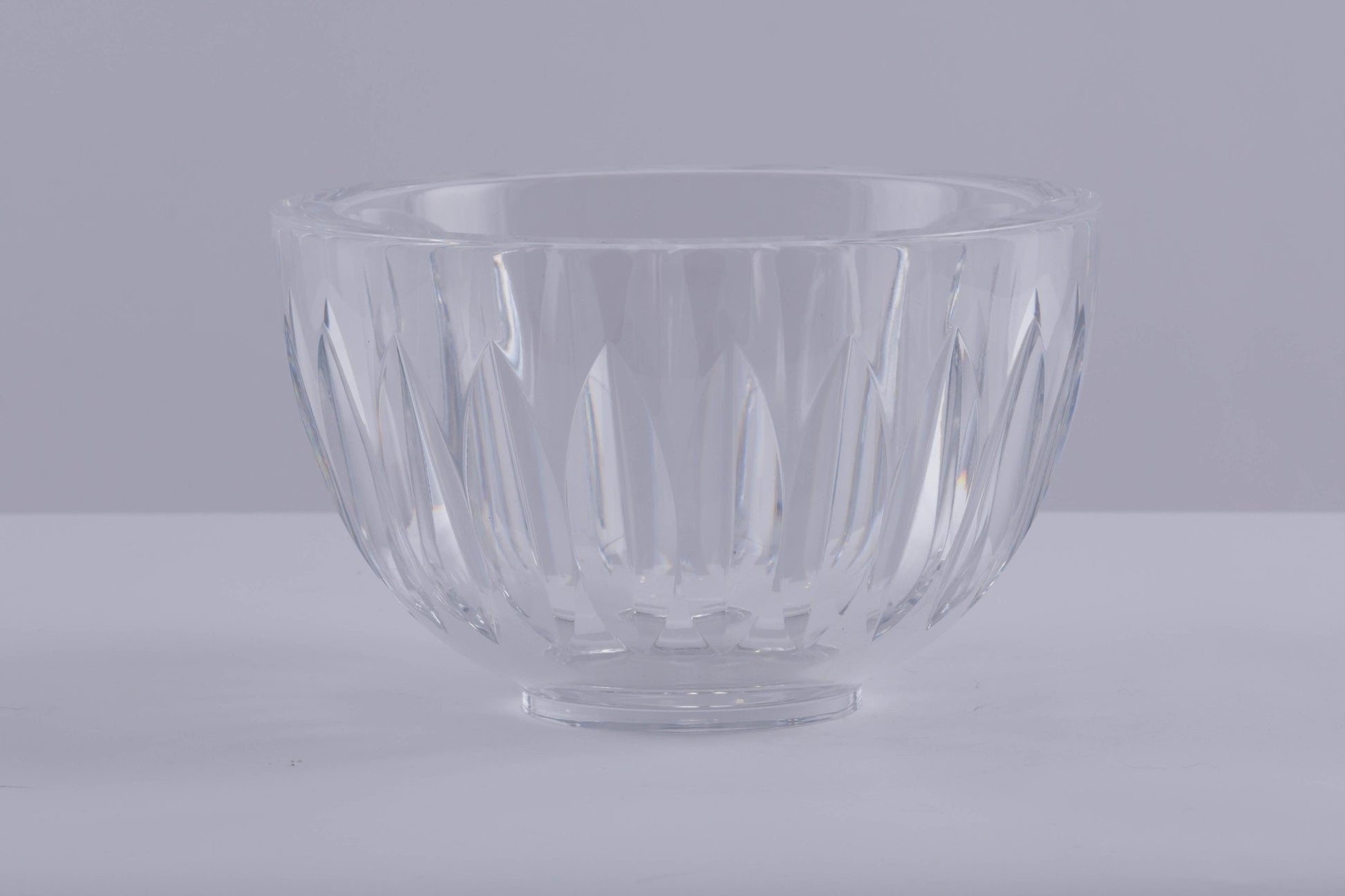 Orrefors heavy cut crystal bowl with wedge-shaped cuts creating prismatic light reflections, designed by Sven Palmqvist