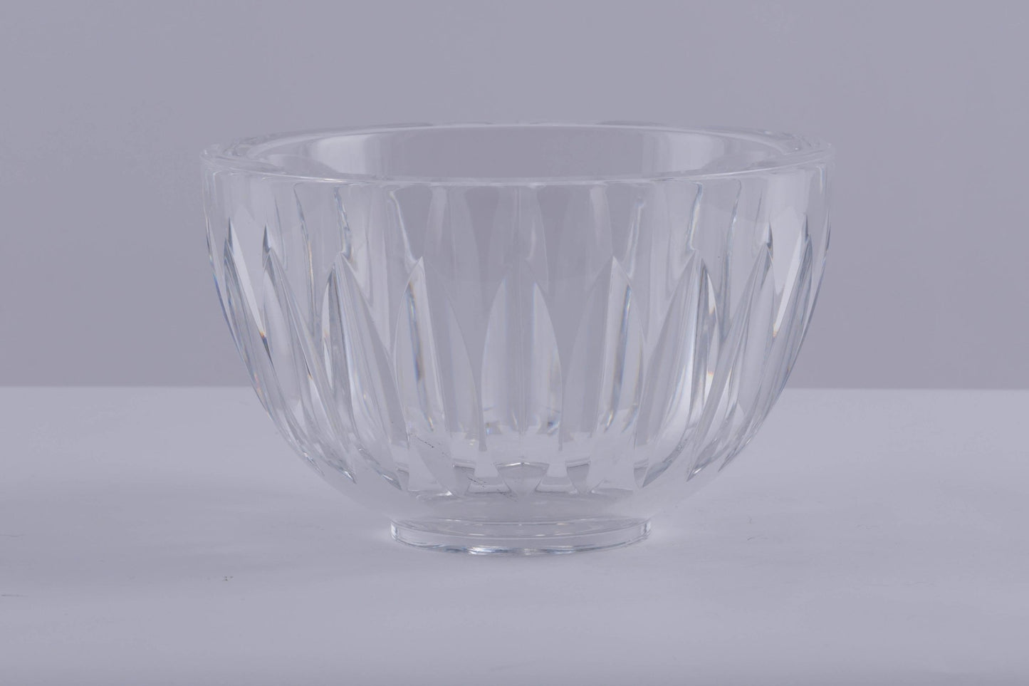 Orrefors crystal bowl designed by Sven Palmqvist with deep wedge cuts creating a prismatic light effect.