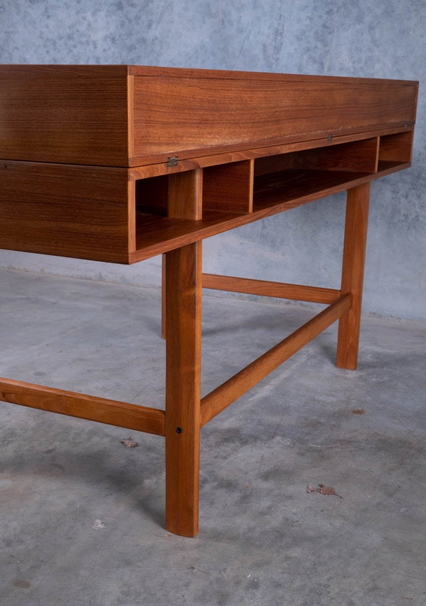 Mid-century modern rosewood desk with flip-top compartments and open storage cubbies on wooden legs
