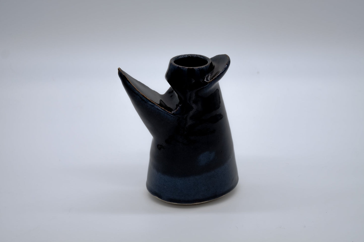 Studio pottery art vase with tapered cylindrical form and protruding spout-like elements in dark glazed finish