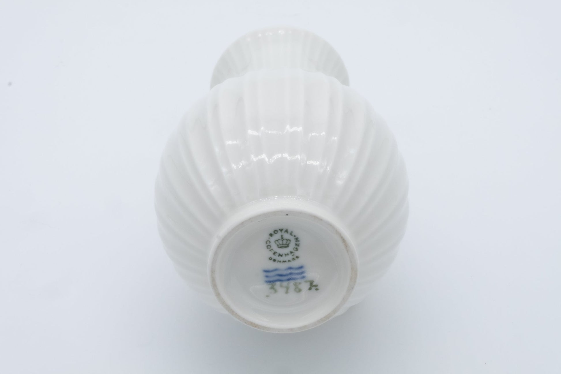 Bottom view of Royal Copenhagen white fluted porcelain bud vase with maker’s mark and model number 376K