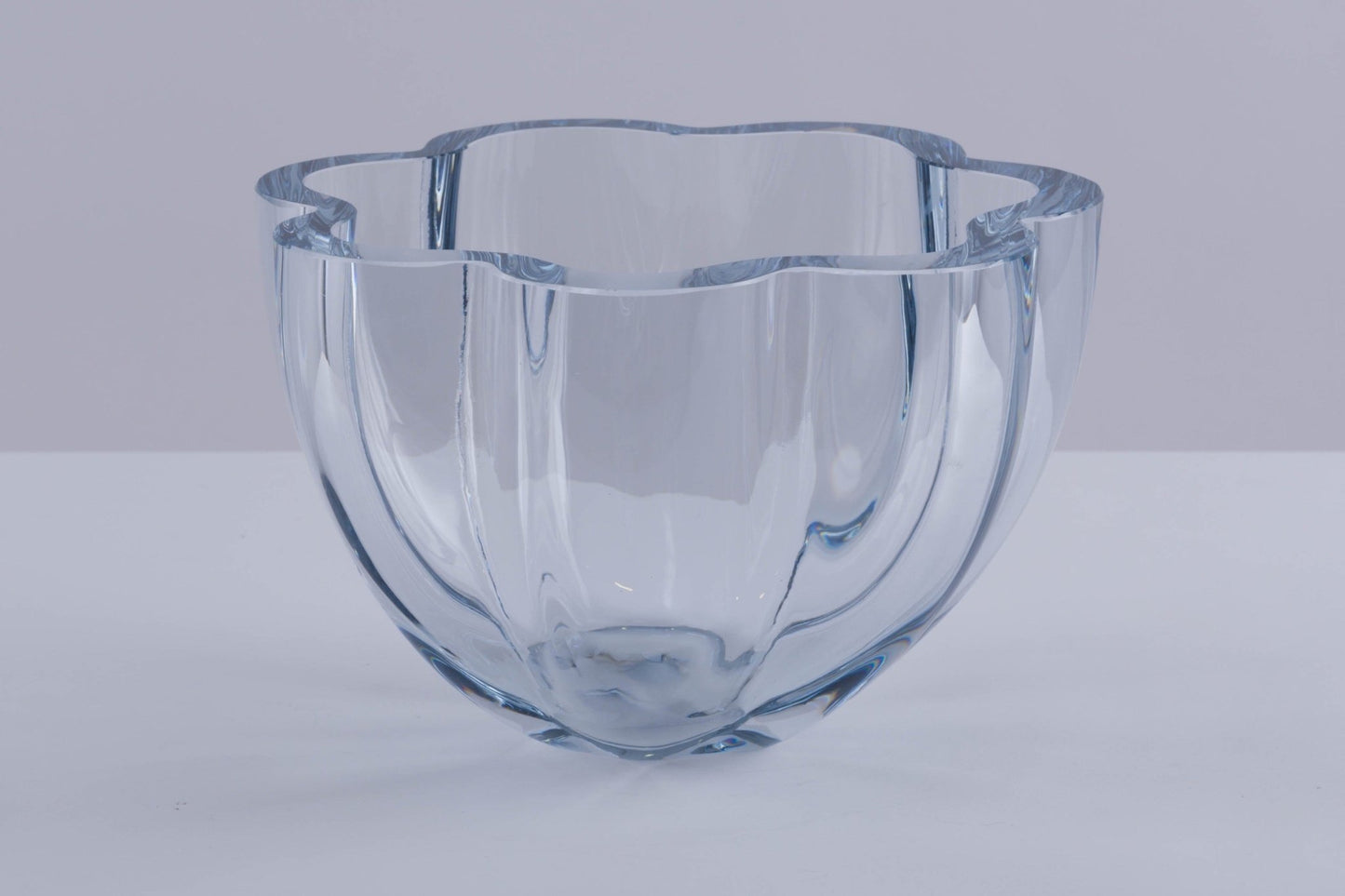 Strombergshyttan Glass Company crystal bowl with thick walls and scalloped rim, clear glass with blue hue, hand signed T463.