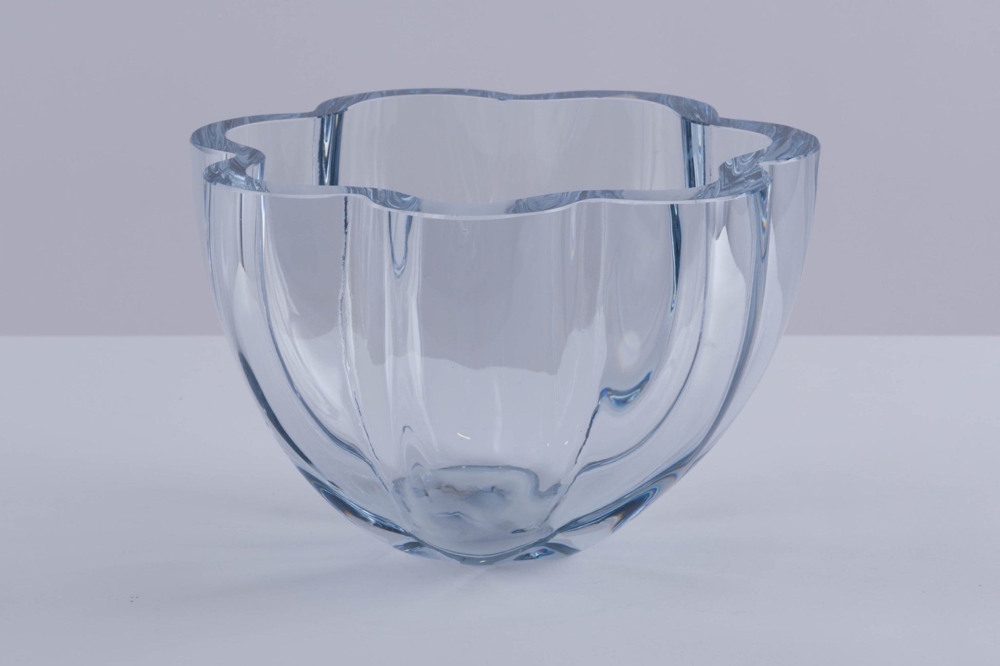 Strombergshyttan Glass Company crystal bowl with thick walls and scalloped rim, clear glass with blue hue, hand signed T463.