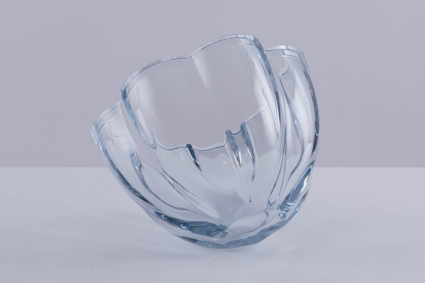 Strombergshyttan Glass Company crystal bowl with thick walls and scalloped edges in light blue hue, hand signed T463.