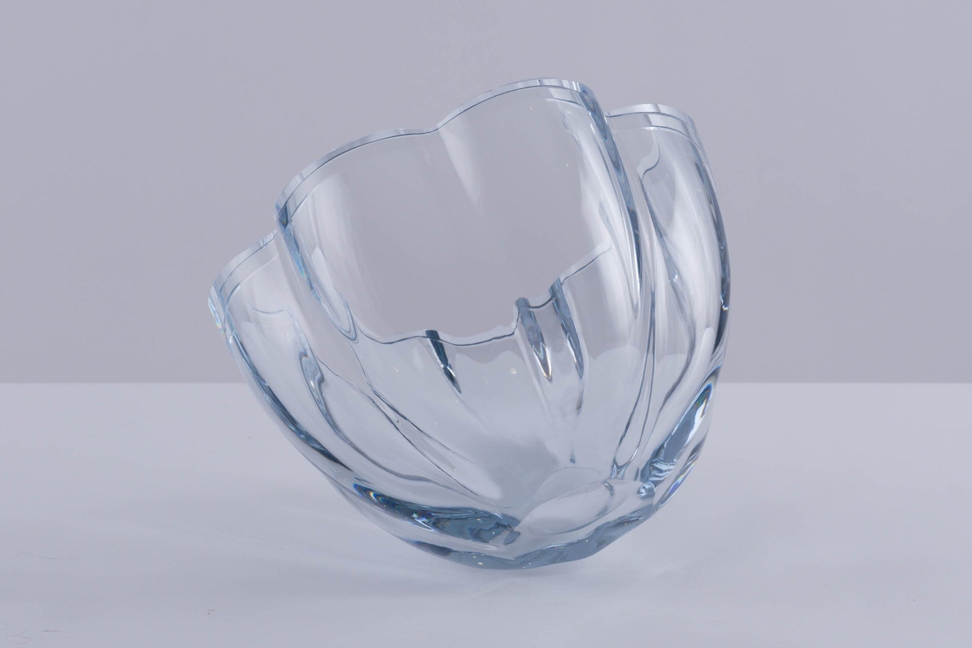 Strombergshyttan Glass Company crystal bowl with thick walls and scalloped edges in light blue hue, hand signed T463.