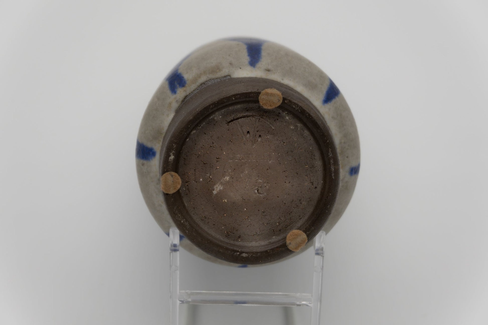 Bottom view of Thomas Toft pottery vase with visible signature and blue abstract glaze on stoneware from Denmark