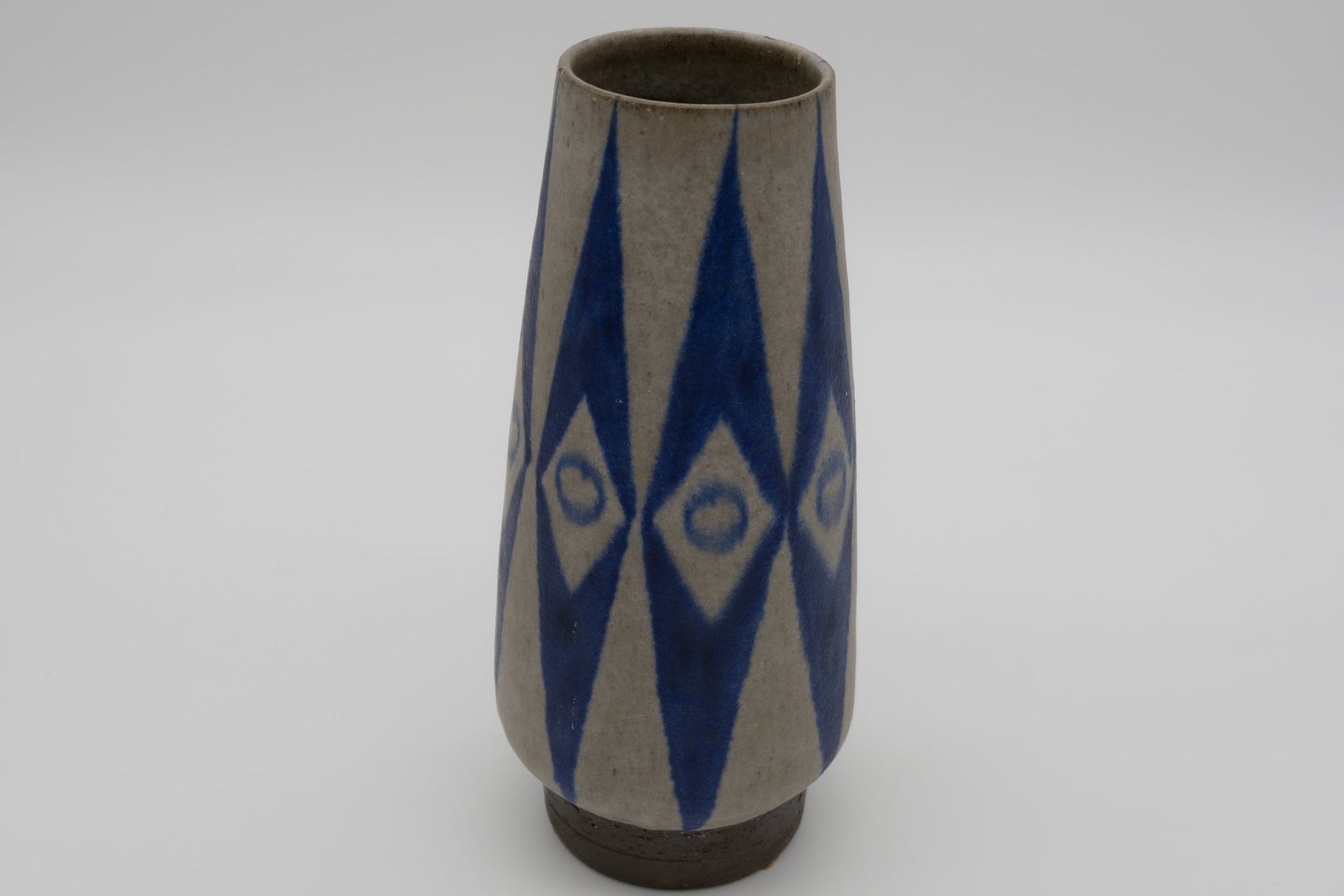 Thomas Toft 1950s Danish ceramic vase with tapered body and bold blue abstract geometric glaze design, signed on bottom