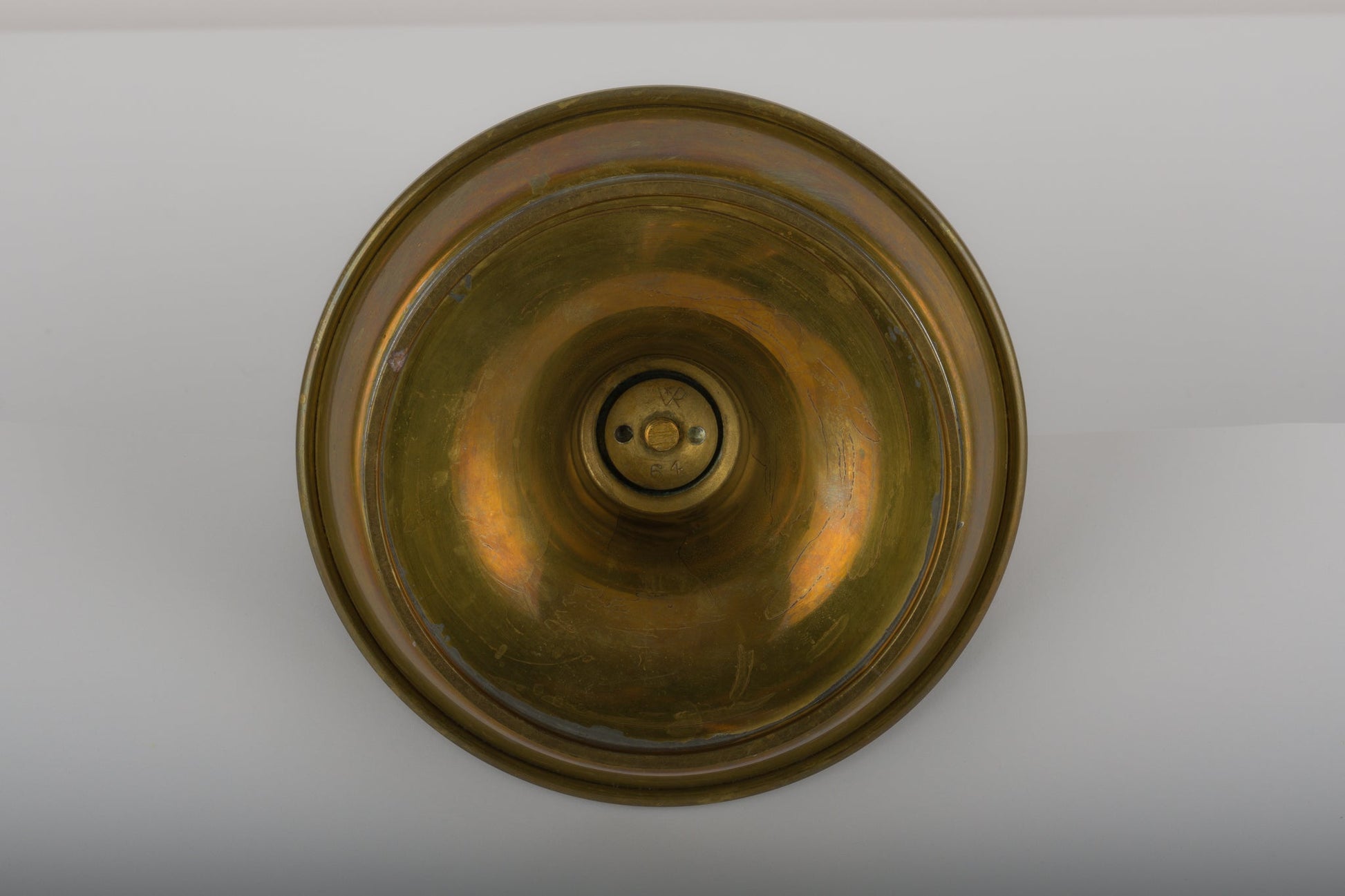 Bottom view of waxed brass candle holder by Tomi Parzinger with subtle design details from the 1990s USA warehouse