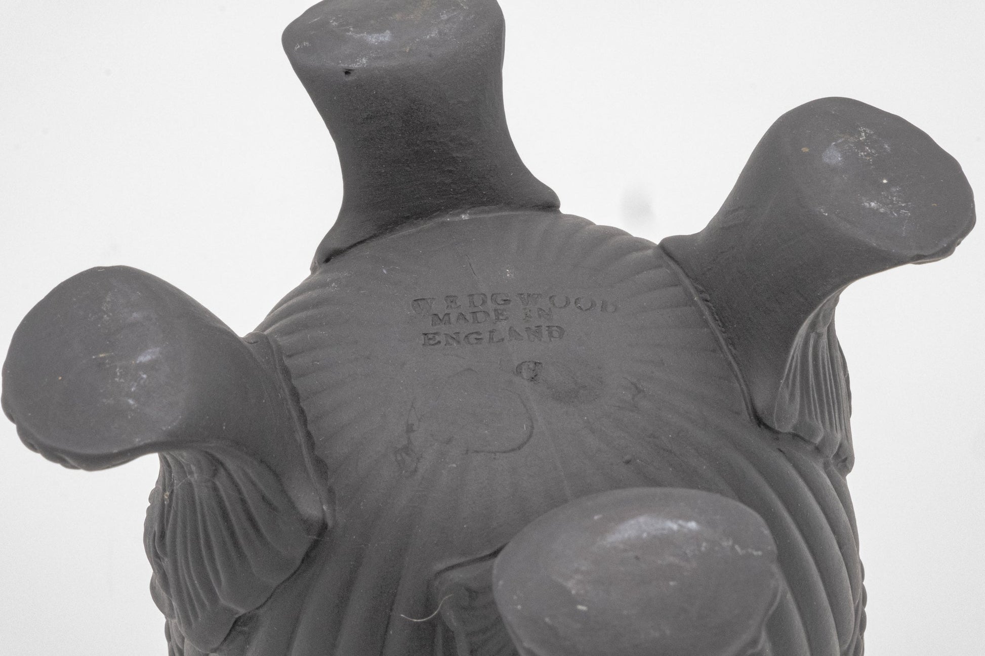 Underside of Wedgwood Solid Black Basalt Vase showing four short feet and embossed maker’s mark from England